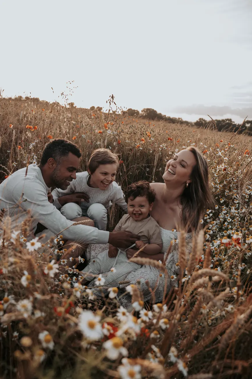 Famille assise dans un champ de fleurs sauvages